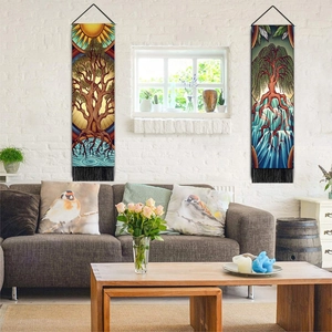 Detail view of two Nordic Tree of Life tapestries with black tassels on a brick wall