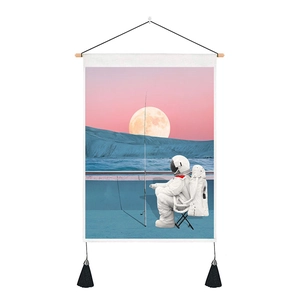 Detail of astronaut tapestry with wooden rod, orange moon, and black tassels decoration