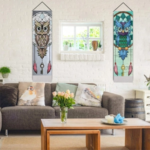 Detailed wall hanging art featuring owl dreamcatcher designs and hanging feather accents