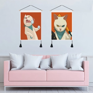 Detailed view of two cat tapestries with wooden rods and black tassels on a white wall