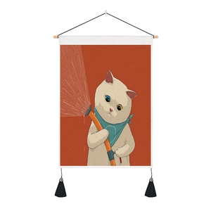 Detail of cartoon cat wall hanging with orange background, wooden rod and black tassels