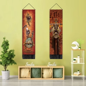Détail de tapisseries gothiques avec crânes et franges noires sur un mur vert clair