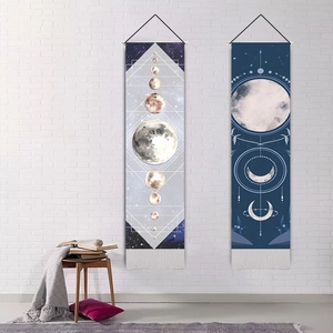 Minimalist moon phase tapestry set with bohemian geometric patterns on white brick wall