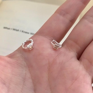 Elegant silver earrings with square champagne zircon shown on hand for size perspective