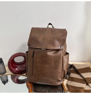 Detail of dark brown vintage PU leather backpack with magnetic snaps and side pockets