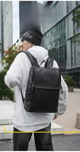 Detail of water bottle side pocket on a sleek black leather commuter backpack for men