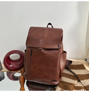 Macro shot of brown PU leather backpack texture with magnetic snap and side pocket