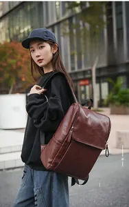 Detail of vintage brown leather backpack texture and side zipper on a stylish rucksack