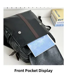 Close-up of front pocket with magnetic flap on black PU backpack showing large storage capacity