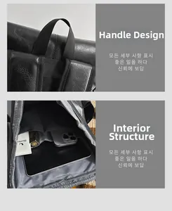 Detailed view of the durable top handle and organized interior compartments of the black backpack