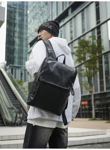 Detailed view of black PU leather backpack with minimalist flap design for urban commute