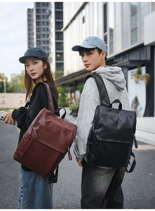 Minimalist leather backpacks in black and brown shown in an urban street setting