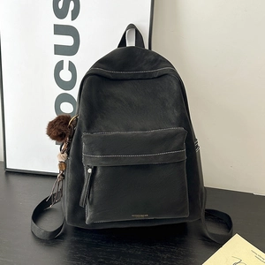 Minimalist black PU leather backpack with white stitching and plush ball charm