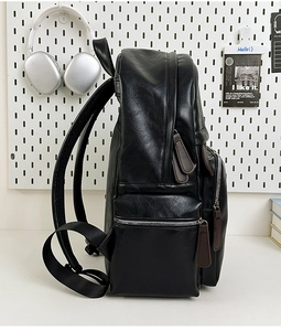 Side view of large capacity black PU leather backpack showing compartments and texture