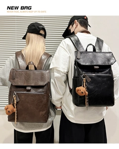 Detail of vintage leather backpacks in black and brown with spacious flip-top design