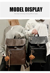 Detail shot of vintage leather backpack with flap closure and cute plush bear charm