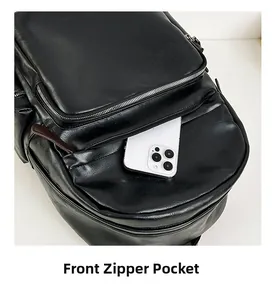 Detailed view of the front zipper pocket on a black leather backpack for large smartphones