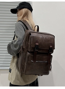 Détails d'un sac à dos vintage marron foncé avec de multiples poches et boucles
