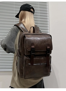 Vista detallada de mochila vintage de cuero marrón con múltiples bolsillos y hebillas