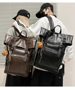 Detail view of large capacity vintage faux leather backpacks with plush bear charm