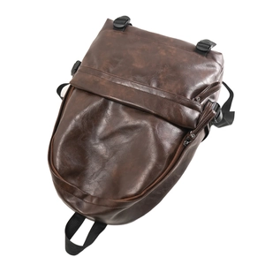 Detail view of vintage dark brown faux leather backpack featuring adjustable buckles