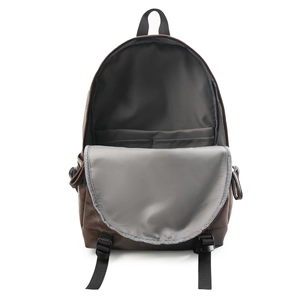 Detail view of brown leather backpack interior with gray lining and dual slip pockets