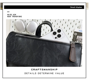 Detail view of large backpack featuring wrinkled leather texture and smartphone storage pocket