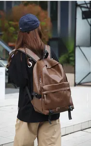 Street view of a dark brown vintage leather backpack showing large main pocket and side buckle