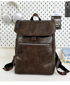 Detailed macro view of the vintage brown leather texture and zipper of the travel backpack