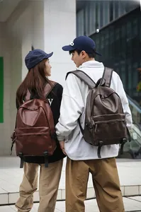 Outdoor street shot of models wearing vintage brown PU leather casual backpacks