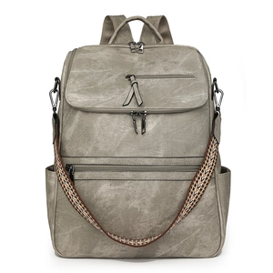 Detail view of vintage grey backpack with multi-pocket storage and woven strap