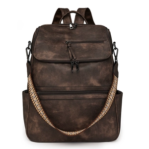 Detail view of vintage brown PU leather backpack with geometric woven shoulder strap