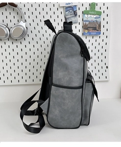 Close-up of minimalist grey PU leather backpack side pocket and durable zipper detail