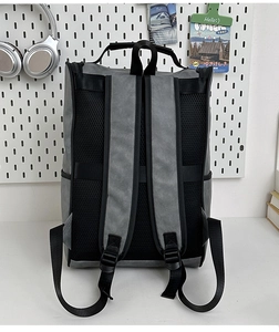 Close-up of the gray and black backpack featuring a breathable mesh back panel and straps