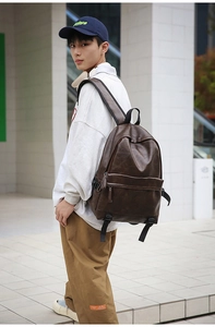 Outdoor shot of a vintage dark brown PU leather backpack with minimalist urban street style