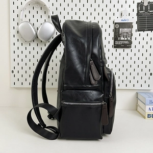 Minimalist black PU leather backpack for students with large capacity and side view profile