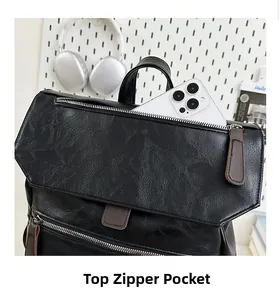 Detail view of the top zipper pocket on this black pebbled leather backpack for storage