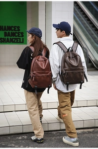 Detail of retro PU leather backpacks in dark brown and reddish brown with texture