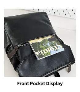 Macro detail of the large front zipper pocket on this black faux leather laptop backpack