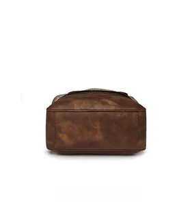Detail shot of the reinforced bottom of this brown vintage leather backpack with stitching