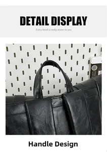 Detail showing the reinforced top handle and litchi texture on the black leather backpack