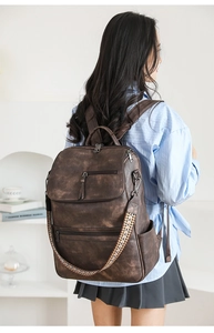 Close-up of vintage brown backpack with textured faux leather and woven shoulder strap