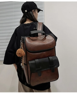 Detailed side view of vintage brown PU leather backpack featuring a cute bear keychain charm