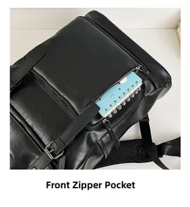 Detailed view of the front zipper pocket on a black leather backpack for storage