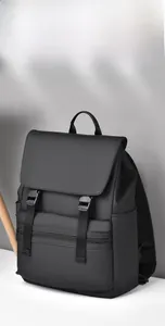 Close-up of black matte waterproof backpack with buckle straps and a front zipper pocket