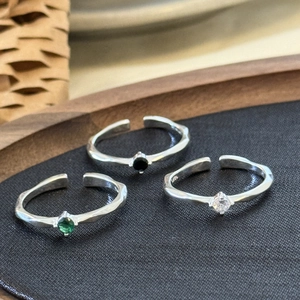 Macro detail of S925 sterling silver hammered rings with colorful zircon gemstones