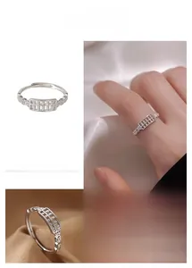 Detail of abacus ring design with coin cutout patterns and adjustable silver band