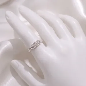 Silver abacus ring with hollow coin design shown on hand over white silk fabric