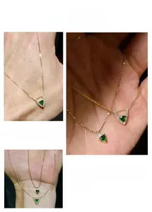 Detailed view of triangular green zircon necklace with micro-pave crystals on gold chain
