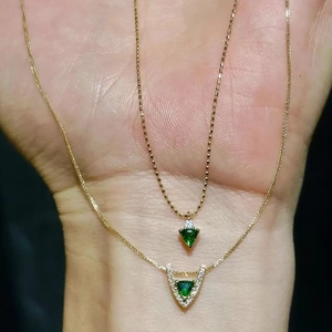 Exquisite gold necklace set featuring green triangle zircon pendants with micro-pave accents